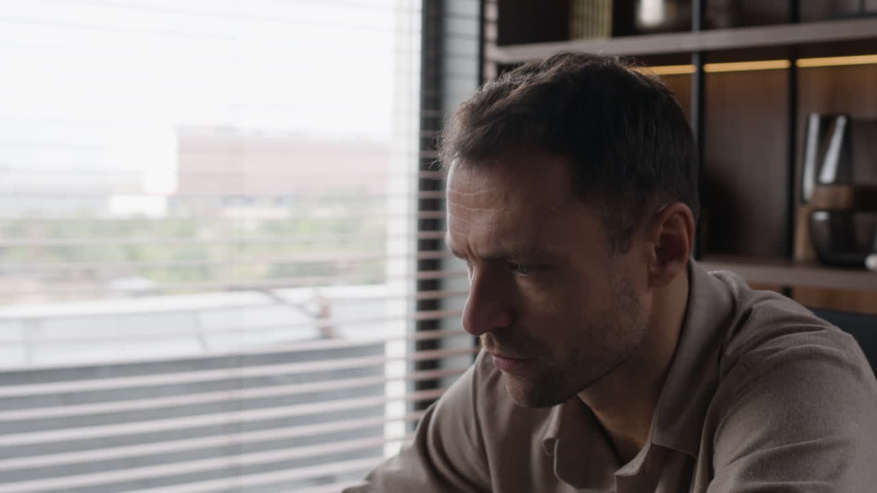 Man looking out window