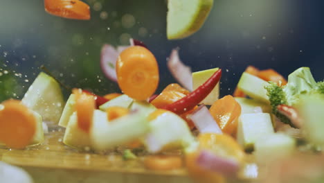 chopped vegetables splashing on a wooden cutting board