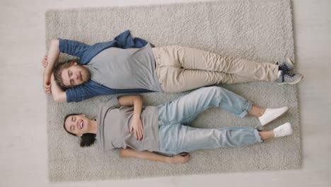 couple relaxing on rug