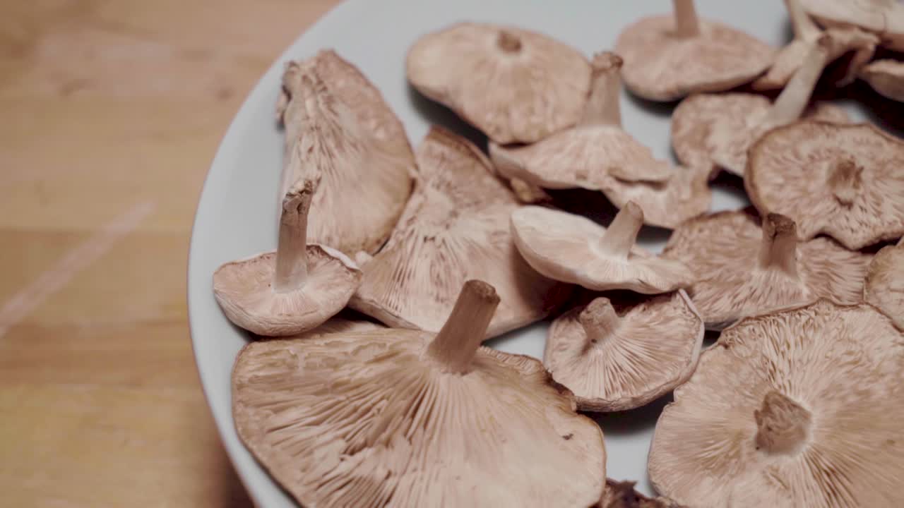setas silvestres girando sobre un plato fuera del centro, primer plano