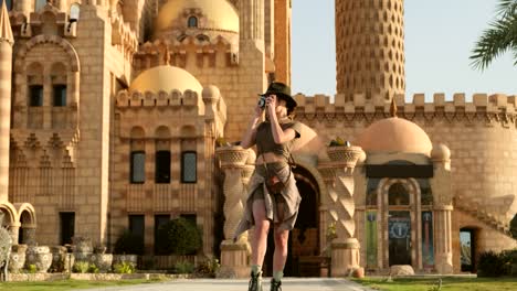 beautiful tourist stands against the background of a muslim shrine