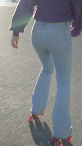 a person roller skating outdoors in bell-bottom jeans