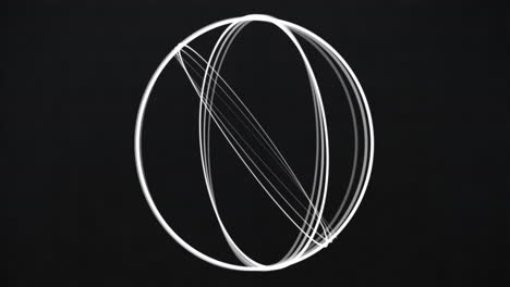 animation of white 3d rings pattern rotating on black background