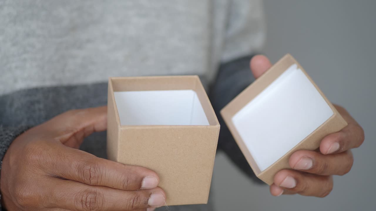 Close Up of Hands Opening a Small Thank You Gift Box