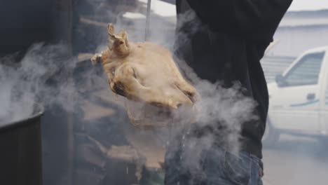 african man taking the meat with a stake