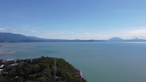 4k drone shot of a beautiful bay with mountains in the background in north queensland, australia