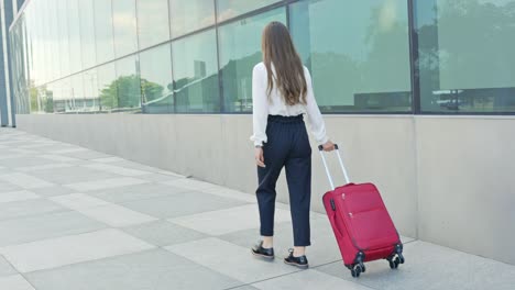 beautiful brunette entrepreneur travel with luggage and classy clothes