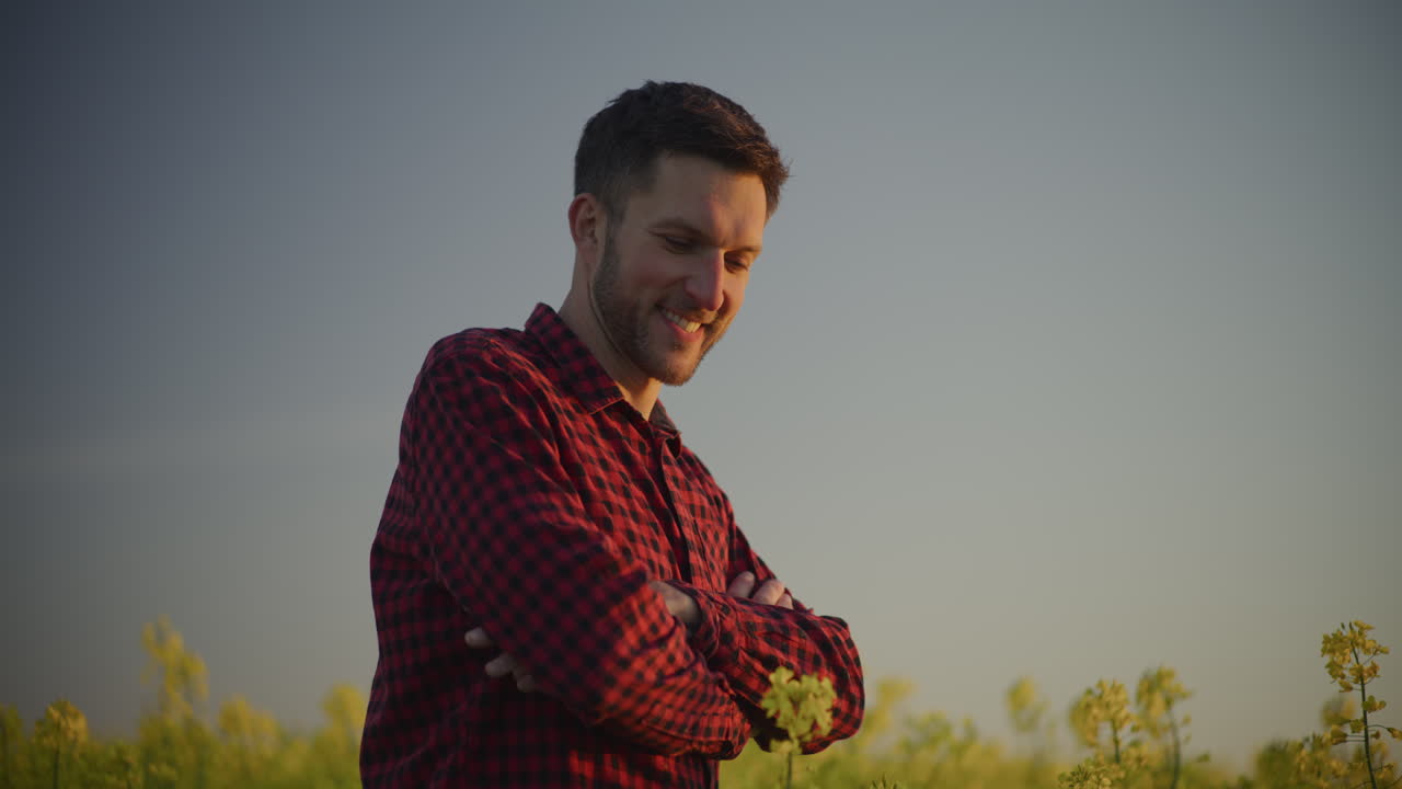 Happy Farmer in Blooming Rapeseed Field Portrait