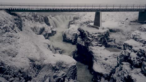 peaceful winter scenery in kolugljufur canyon and waterfall in north iceland - wide shot