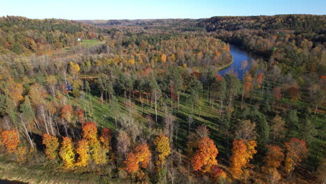 autumn colors over tranquil river valley in a forested landscape