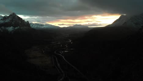 aerial sunset landscape shot of the snow covered mountains in utah during sunset.