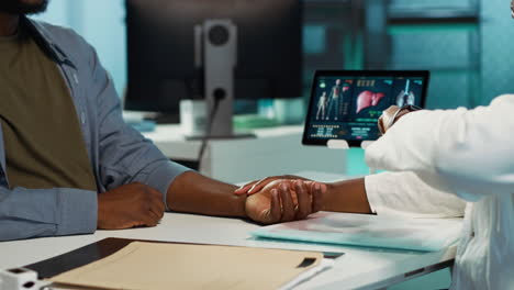 physician measuring the heart rate of a young man by using her smartwatch