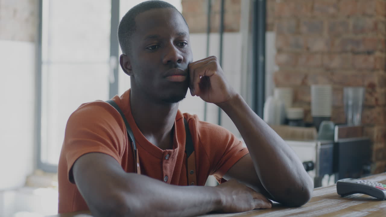 Man Looking Thoughtful in a Cafe