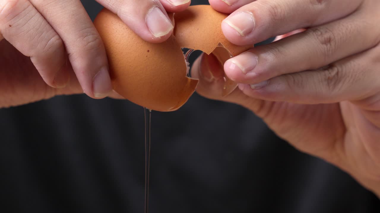 Macro shot of an eggshell cracking in a professional kitchen