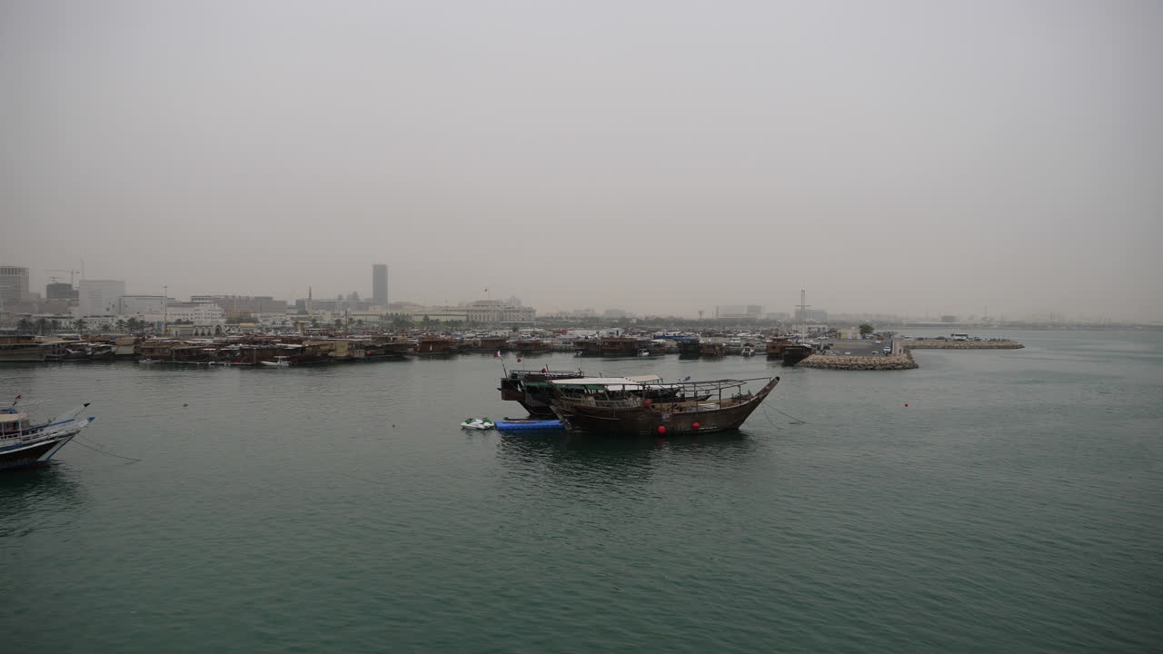 Skyline della splendida Doha - tradizionale barca dhow ormeggiata in primo piano - Doha, Qatar
