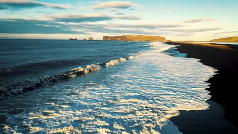 dramatic waves crashing on black sand beach in iceland