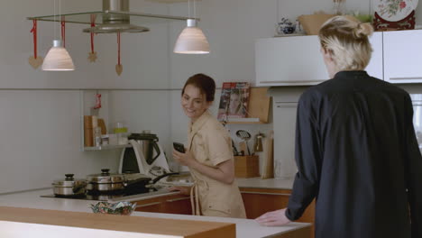 two people interacting in a modern kitchen