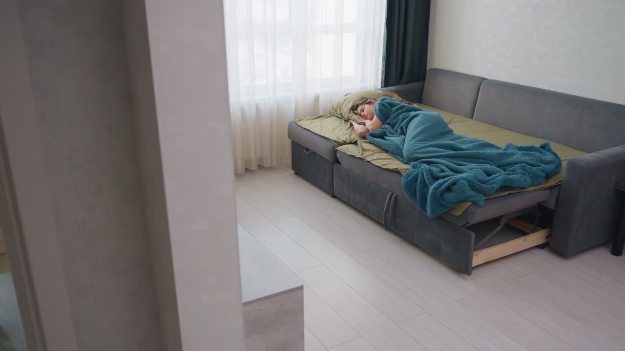Artist On Sofa, Woman Artist Relaxes Amidst Simplicity, Creative Woman Pauses On Comfortable Sofa With Calming Decor, Caucasian Female Artist Takes Moment Of Rest In Cozy Studio Space