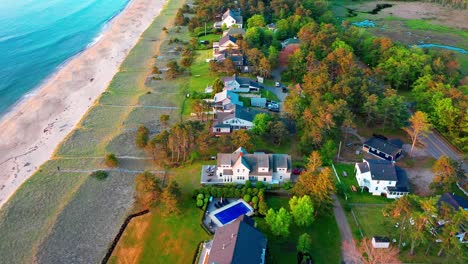 drone footage of a beautiful maine beach house surrounded by sand and sea. perfect vacation home with patio, deck, ocean view windows, and prime real estate steps from the atlantic’s surf.
