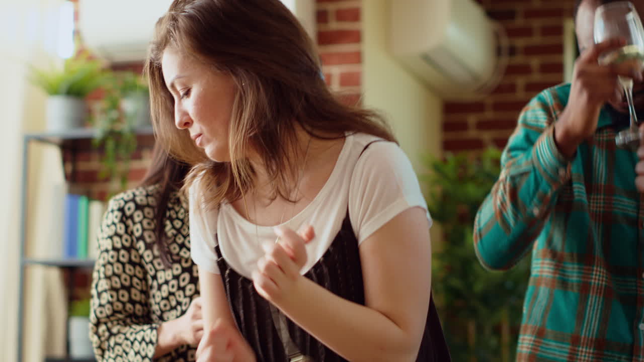Group of people dancing on energetic beats during weekend hangout, shaking hips