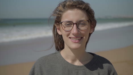 una joven sonriente con el pelo largo mirando a la cámara.