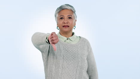 Mature-woman,-thumb-down-and-portrait-in-studio-by