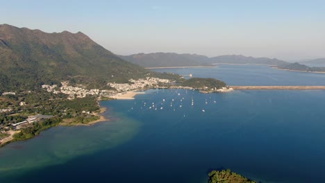 Hong-Kong-Bucht-Mit-Kleinen-Booten-Und-Umliegender-Grüner-Landschaft,-Luftbild