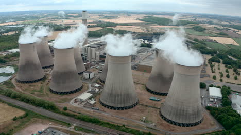 wide circling drone shot of large power plant cooling towers