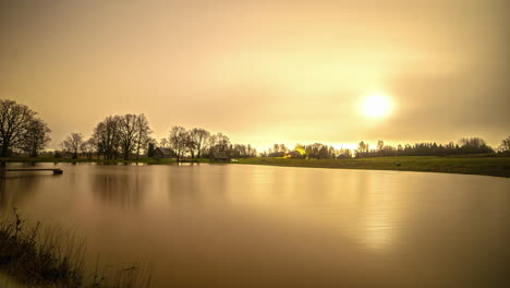 time lapse shot of flying stars and bright rising moon at night illuminating nature lake - twilight shot until morning - nature scene