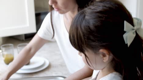 cute girl helping mom to wash dish