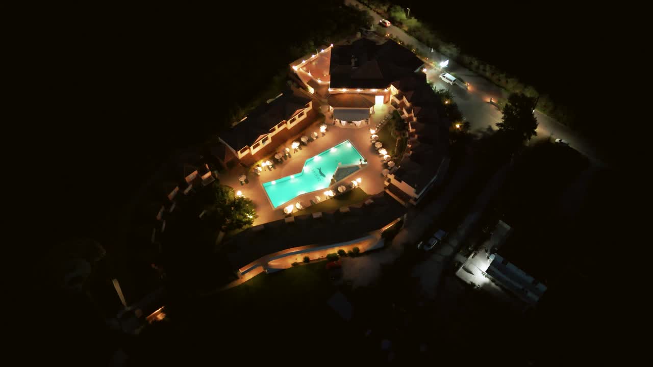 Lush illuminated villa and pool at night in Zante, Greece