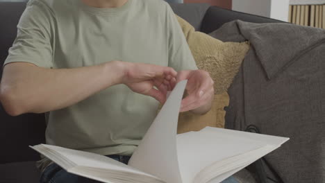 close up view of caucasian young man touching a book