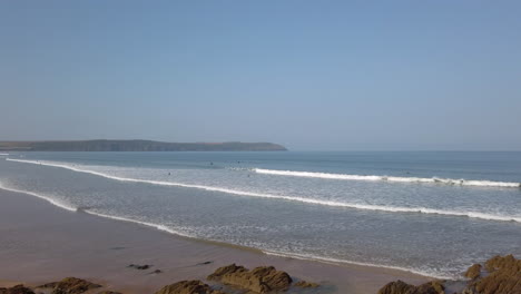 Static-Shot-of-Surfers-Floating-in-the-Waves-on-a-Summer’s-Day