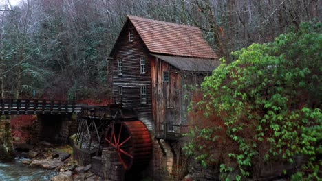 Glade-Creek-Grist-Mill-in-West-Virginia-with-bridge-and-drone-video-moving-out