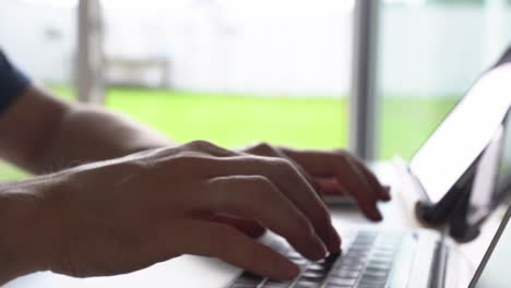 the concept of remote work. close-up of male hands typing on the keyboard in search of information. a freelance copywriter is working on a project.