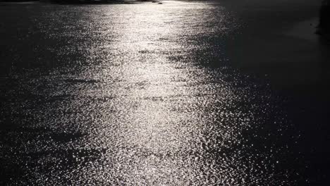 shining surface of night river. water with ripples on the surface. blur monochrome water background.