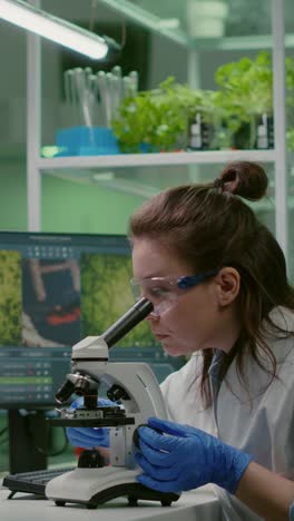 female scientist using microscope in a laboratory for research