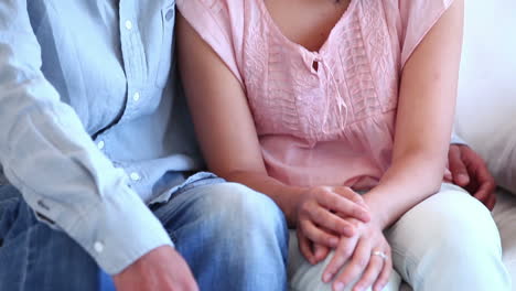 Couple-smiling-as-they-sit-together