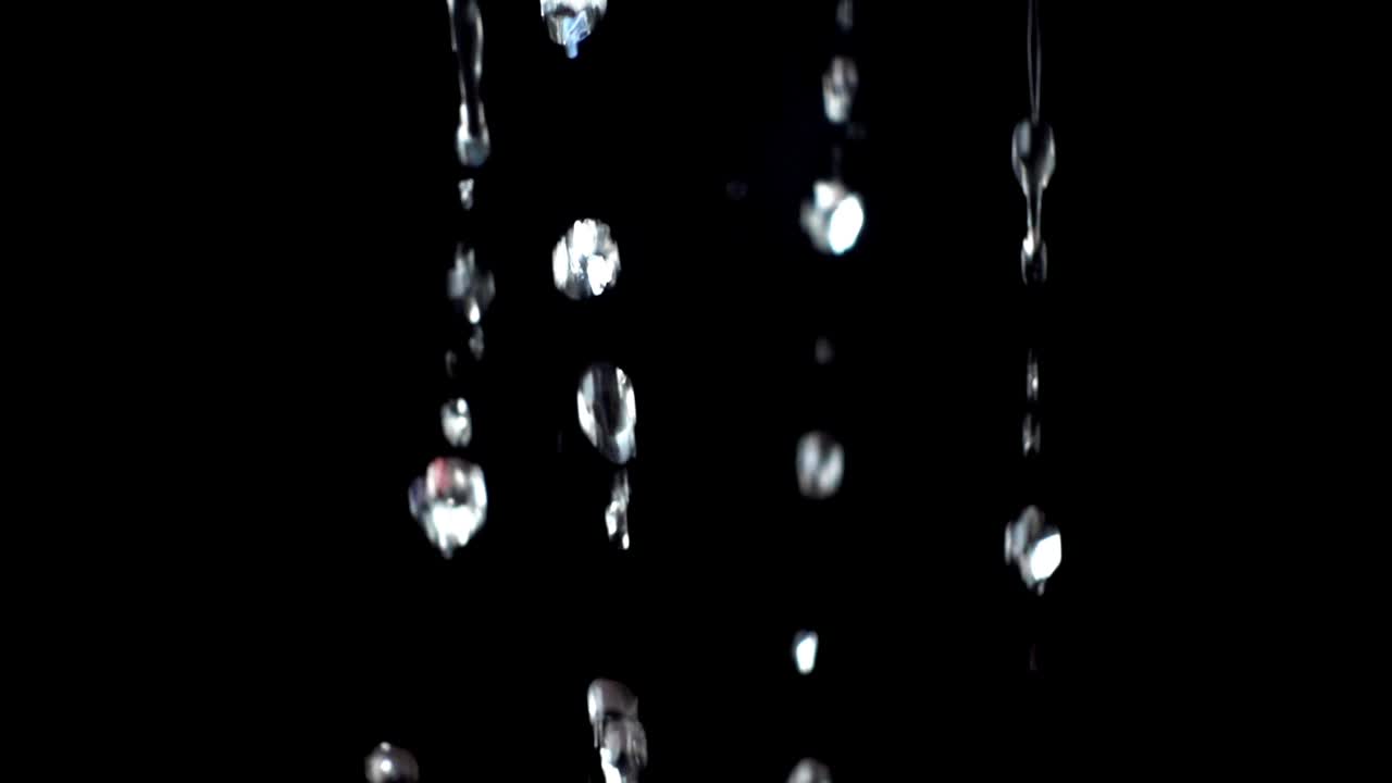 Water on a black background. Slow motion
