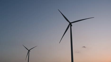 Wind-Turbines-Silhouette-against-the-Blue-sky-during-Sunset,-clean-alternative-energy-in-Thailand-and-mainland-Southeast-Asia