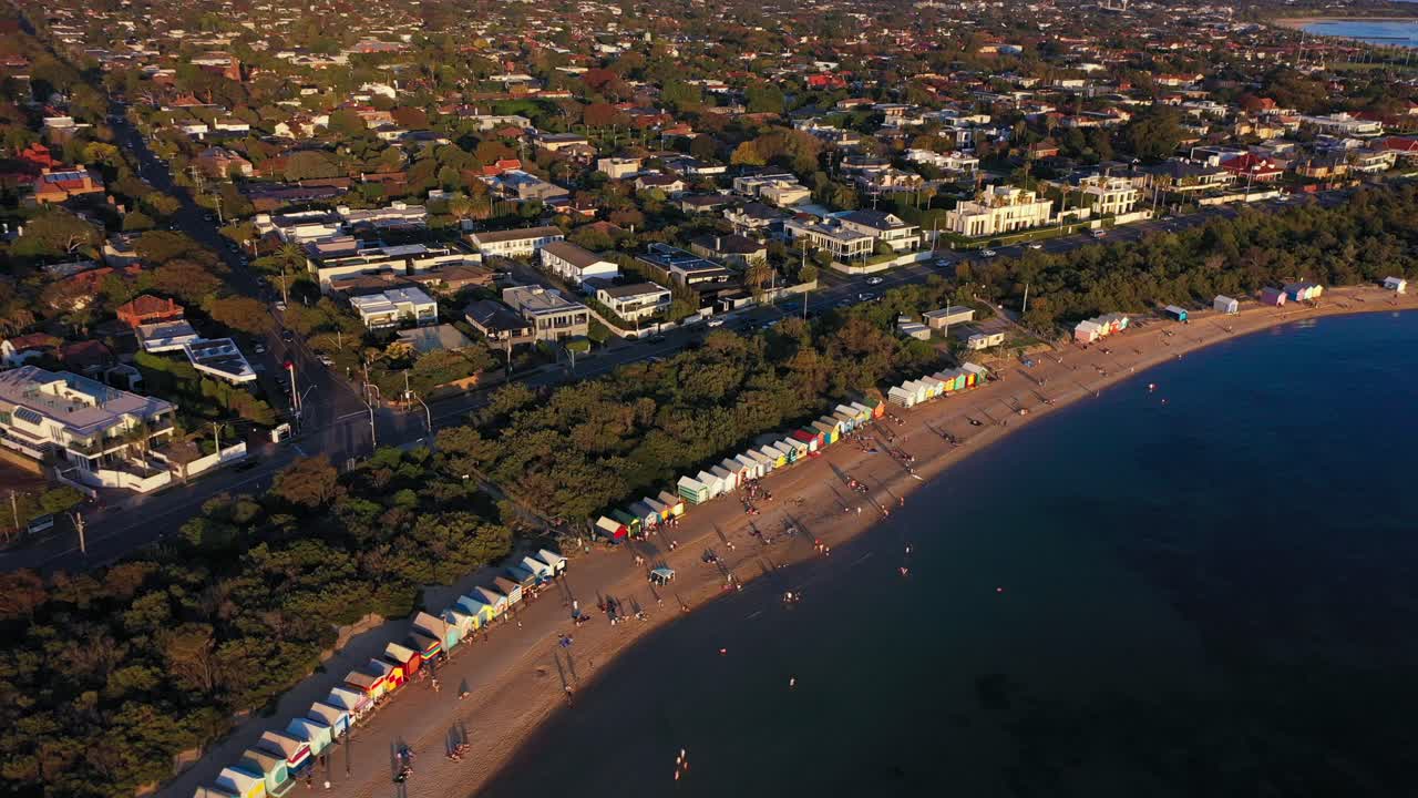 Panning aerial footage of Brighton's famous colourful bathing boxes in Melbourne, Australia