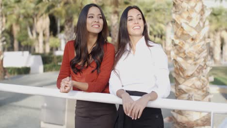 young women chatting in a tropical urban park