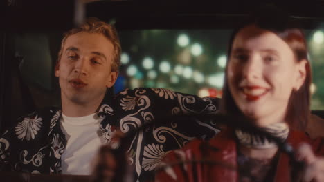 man chatting with female driver during night ride in retro taxi cab