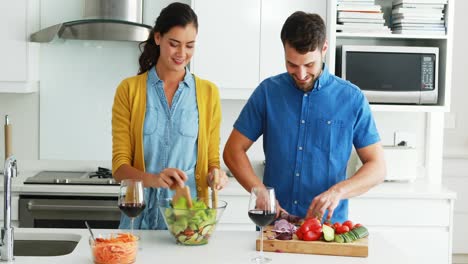 couple preparing food together in the kitchen