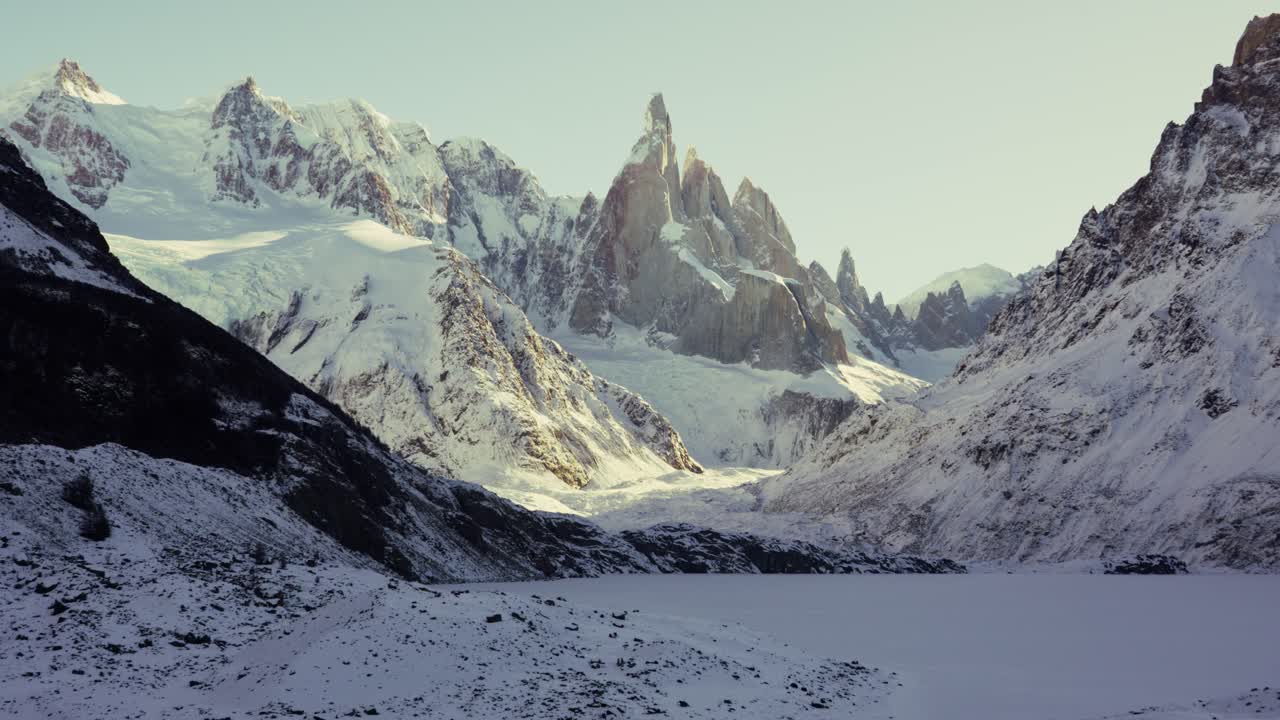 Close-up static view of Cerro Torre and snow-covered lake in Patagonia, Argentina