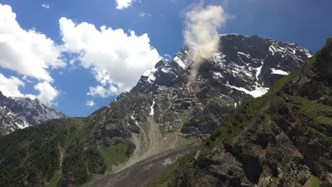 Drone-shot-of-Nanga-Parbat,-Fairy-Meadows-Pakistan,-looking-up-towards-a-mountain-peak-with-clouds-coming-off-ridge,-cinematic-aerial-shot