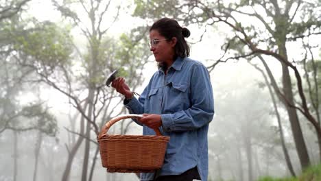 Woman-with-indigo-milk-cap-mushroom-in-forest