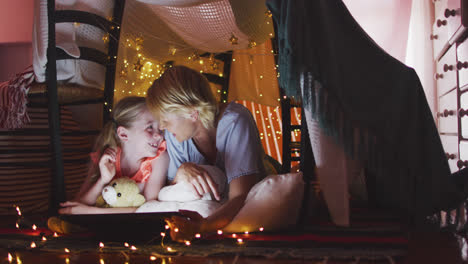 Side-view-of-Caucasian-woman-reading-a-story-to-her-daughter-at-home