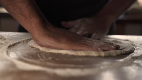 4k male chef kneading homemade pizza dough on wooden table 2