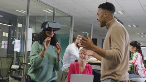 happy diverse male and female business colleagues using vr headset in office